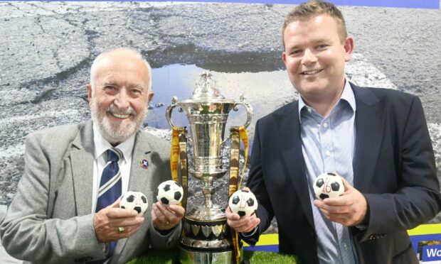 Highland League president George Manson, left, and GPH Builders Merchants managing director Grant Shewan with the Highland League Cup trophy