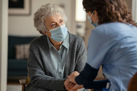 Patient and healthcare professional wearing face masks.
