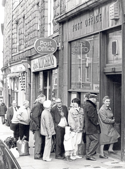 Pensioners and housewives line up outside Torry Post Office.