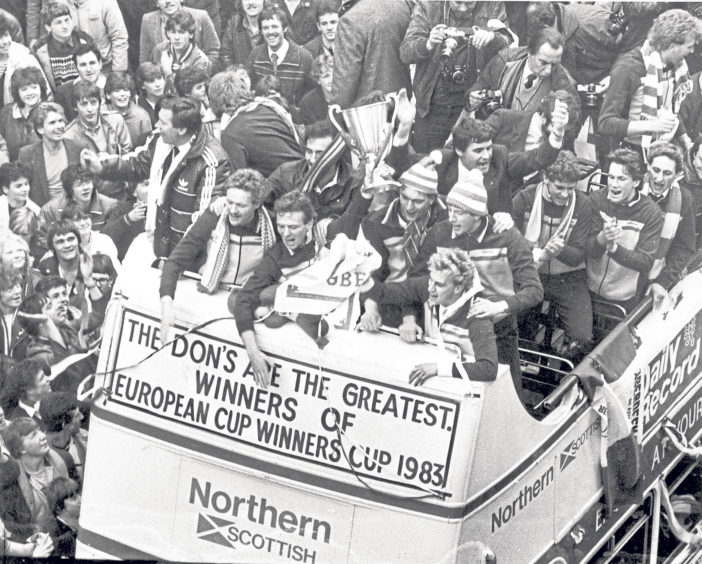 1983: The victorious Dons team display the European Cup Winners Cup from an open top bus after beating Real Madrid 2-1 in the final in Gothenburg, Sweden