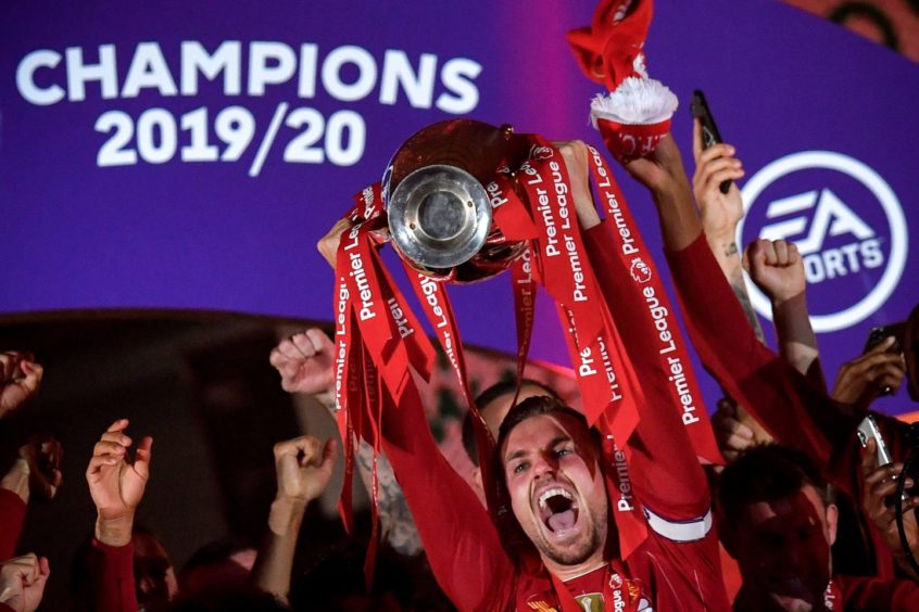 Jordan Henderson lifts up the Premier League trophy that alluded Liverpool for 30 years.