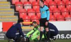 Joe Lewis is treated on the pitch during the Scottish Cup clash with Livingston.