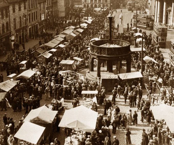 1934: Huge crowds throng the Castlegate in Aberdeen for the Timmer Market in 1934, and no shortage of trams transporting folk to the popular event.