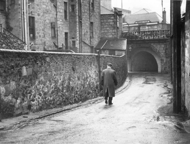 1960: A solitary figure takes a walk down Aberdeen's Union Glen from its junction with Cuparstone Row in January 1960.