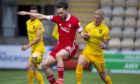 Aberdeen's Connor McLennan and Livingston's Craig Sibbald in action