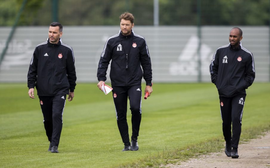 Stephen Glass, Allan Russell and Henry Apaloo walk out to the pitch for Aberdeen training.