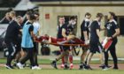 Aberdeen's Andy Considine is stretchered off injured against Qarabag in Azerbaijan.