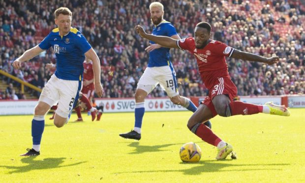 Aberdeen attacker Austin Samuels is closed down by St Johnstone's James Brown (left) at Pittodrie.