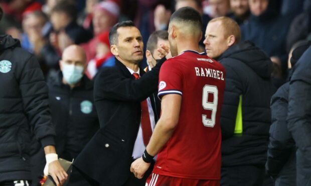 Aberdeen manager Stephen Glass celebrates with Christian Ramirez after defeating Hibs in October.