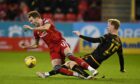 Aberdeen's Ryan Hedges (left) battles with Motherwell's Nathan McGinley during the 2-0 loss.
