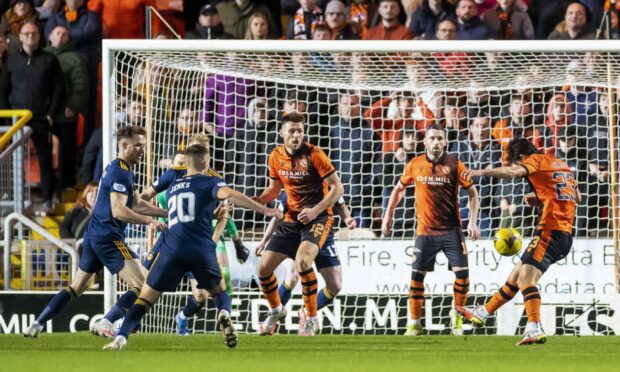 Dundee United's Ian Harkes (R) makes it 1-0 against Aberdeen.