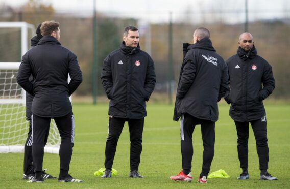 Stephen Glass (centre) and his coaching staff during an Aberdeen training session at Cormack Park, on November 24, 2021.
