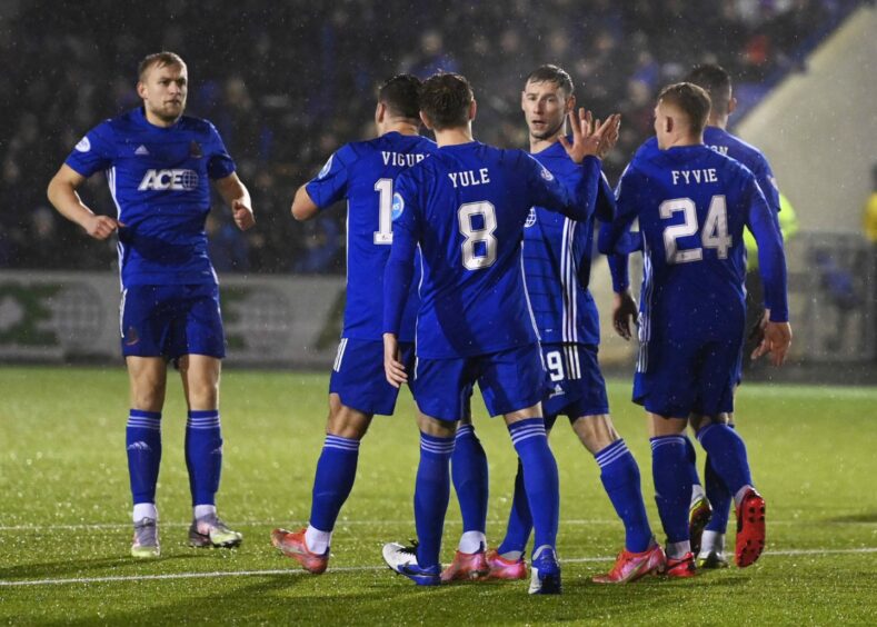 Cove Rangers congratulate Mitch Megginson after he scores from the spot