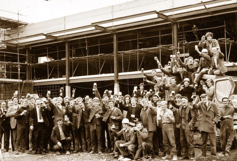 1970: Builders raise their glasses to celebrate the topping out of the new Fine Fare store at Aberdeen's Bridge of Dee in 1970. The store was built on the site of the old greyhound stadium and is now a base for Asda.