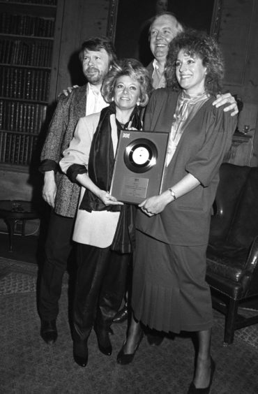 Bjorn Ulvaeus, Tim Rice and Elaine Paige and Barbara Dickson collect a silver disc for sales of the album Chess.