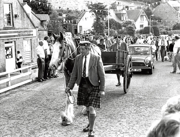 1975: 90-year-old Mary Taylor, of Strathdon, comes to the roadside to watch the Lonach marchers.