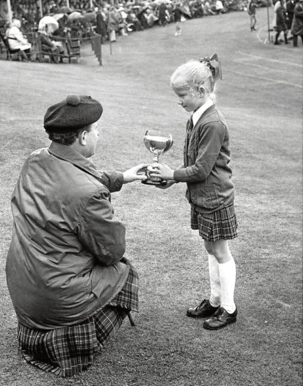 1974: Seven-year-old Braemar youngster Dianne Wright received a trophy from the Duke of Fife for dancing.