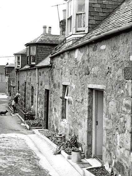1969: A resident outside her cottage in Oldmeldrum’s Southies Close.