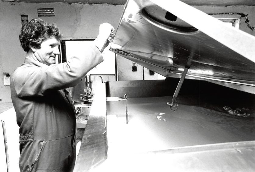 1981: Sandy Burnett from Aberdeen and District Milk Marketing Board checks the day's milk at Cultercullen Farm.