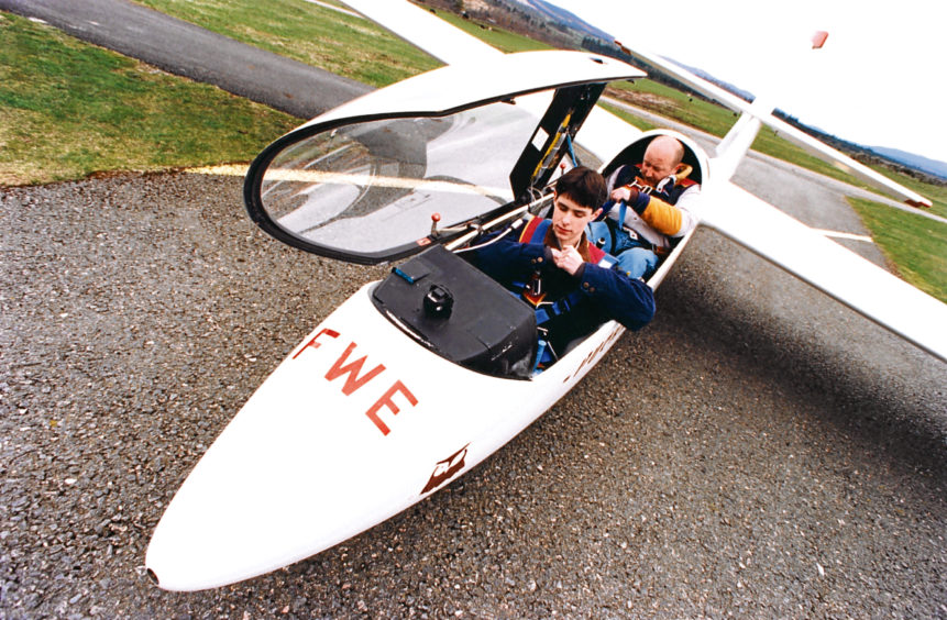 1981: The single-seater Astir CS 77, piloted by Angela Veitch, glides over Dallachy airfield. The River Spey and Spey Bay are in the background.