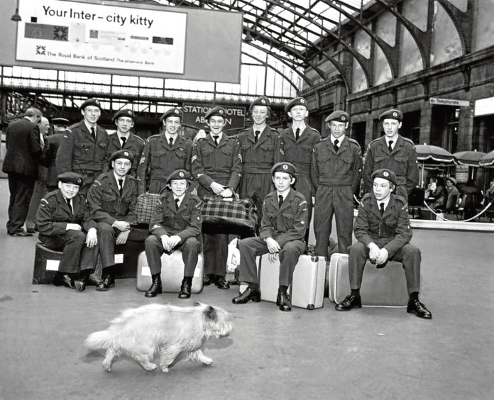 1974: A dog grabs the spotlight as Air Training Corps cadets prepare for a trip at Aberdeen Railway Station.