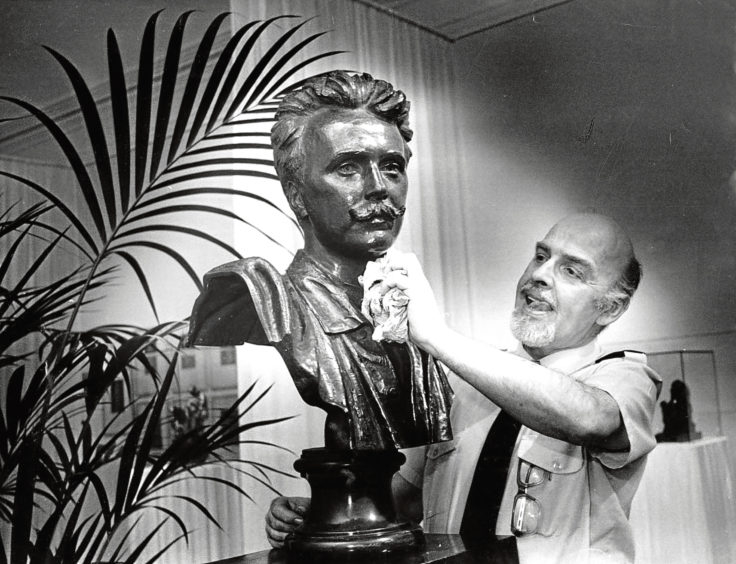 1988: Albert Barnes dusts a bust of Douglas Strachan, who decorated the Trades Hall and Music Hall.