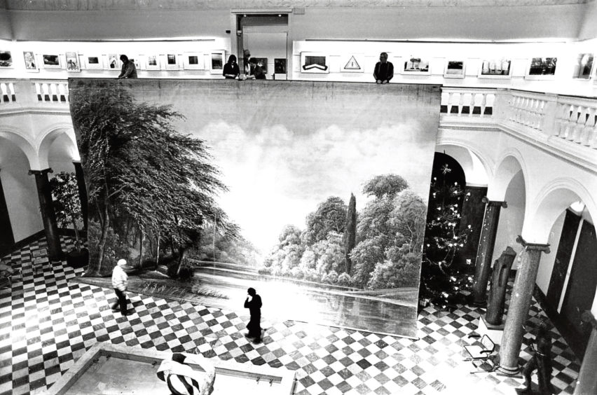 1986: Theatre technical adviser Eddie Swan (on balcony, right) and staff suspend a Victorian scenic painting.