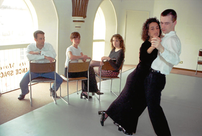 1997: Yolanda Lacoma and Peter Leil, watched by dancers who lost out on tuition when Latin American champions Eduardo and Alison Del Rio’s flight was cancelled.