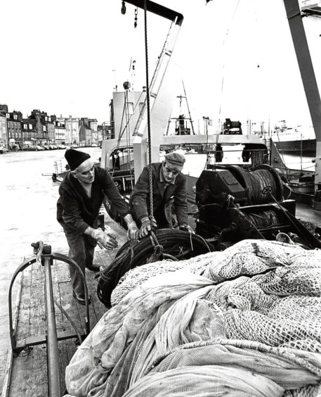 1978: Scotia crewmen busy unloading nets and other gear from the research ship.