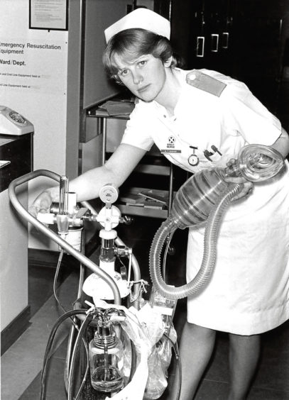 1980: Staff nurse Barrie Buchan prepares to use first line emergency equipment in Ward 51 at Foresterhill.