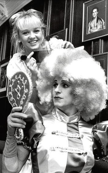 1988: Panto dame in Goldilocks, Wayne Sleep, has his wig touched up by Lisa Maxwell.