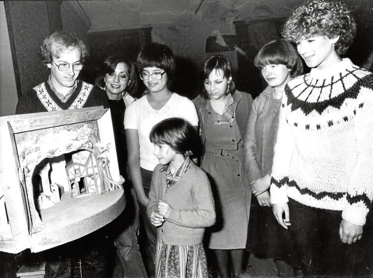 1981: Stage manager Douglas Shepherd shows a model of the Babes in the Wood set to some of the people at auditions.
