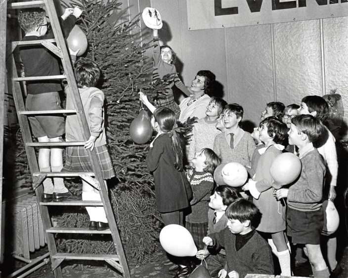 1968: Pupils from Skene Street School help decorate the tree at the Gaumont Gallery.