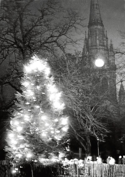 Photograph showing the NCR Dundee factory with a christmas tree lit up outside of it. 14 December 1960.