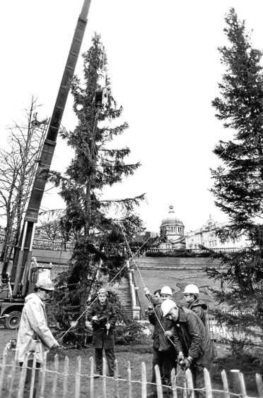 1963: Final touches are put on the tree at Aberdeen railway station, which had a model train track around the base.