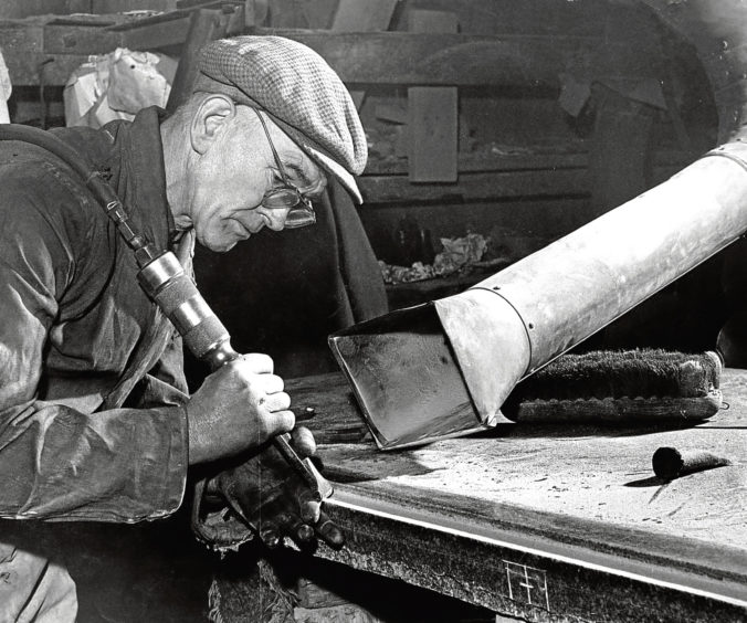 1966: John Steel carves an edge on granite fixing at the MacDonald’s Yard, Aberdeen.