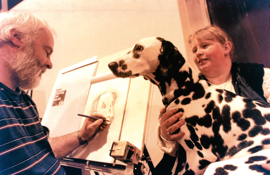 1996: Dalmatian Lucy, held by owner Margaret Robertson, from Edinburgh, has her portrait done by Aberdeen artist Rodney Peace.