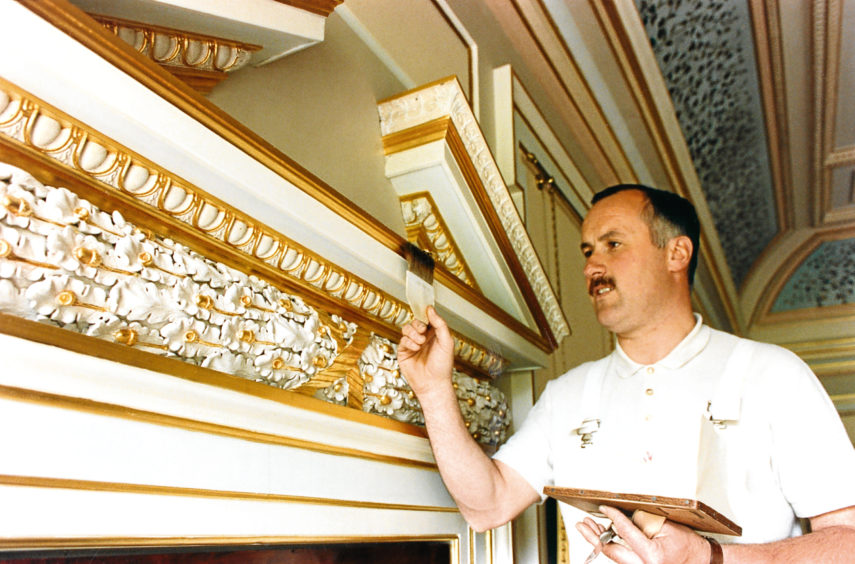 1993: Inverurie craftsman Graeme Sim uses a cushnie and tip to gild a pediment at Haddo House.