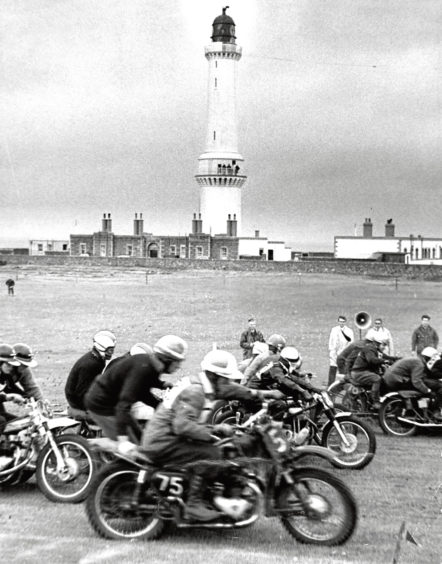 "A competitor takes a corner in front of spectators at the Bon Accord Motor Cycle Club scramble in August 1969."