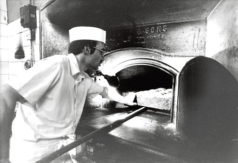 1984: Adam Duguid at Chalmers’ Bakery, Bucksburn, puts a batch of bread in the oven.
