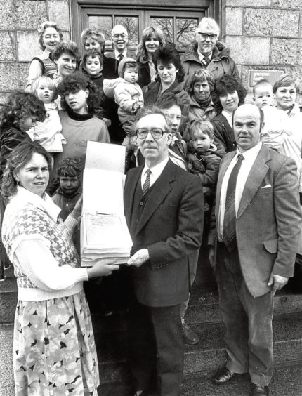 1988: Torphins Hospital Action Group spokeswoman Christine Murray hands over a petition to health board chairman Bill Ellis.