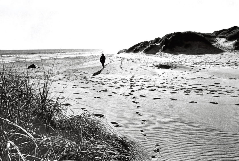 1972: A lone walker enjoys the air on Balmedie beach