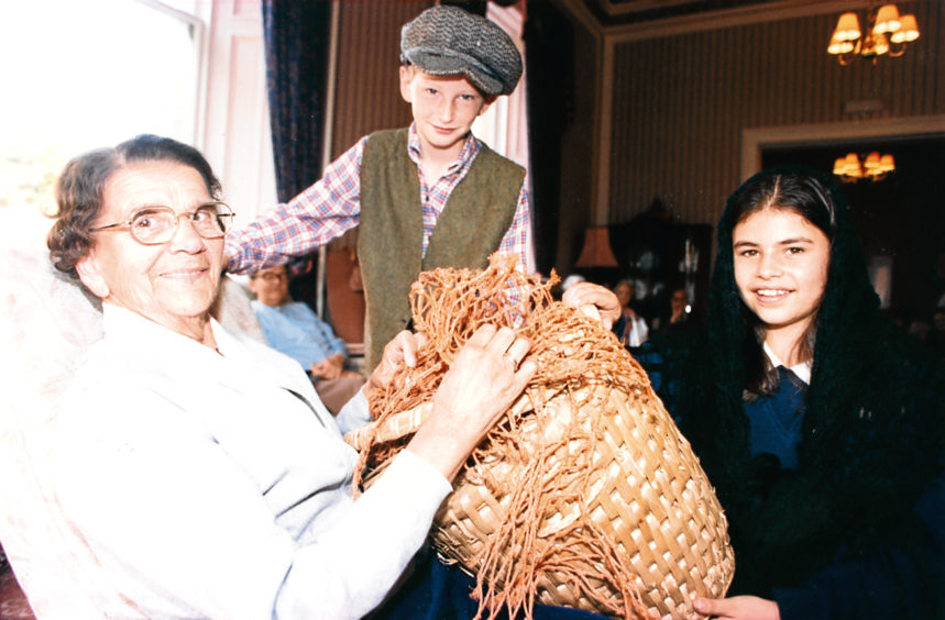 1996: Balmedie House resident Janet Reith, with Brian Milne, a pupil of Balmedie Primary, who along with class mates presented a short play about salmon fishing in the village.
