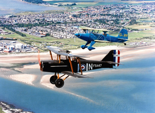 1993: Two bi-planes taking part in the Scottish Wings and Wheels Extravaganza soar with the Grampians in the distance. Aberdeen-born surgeon, Neil Geddes, Bridge of Weir, flew the 7/8-scale replica of an SE5A (bottom), which he built himself.