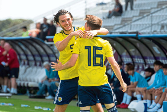 Scotland's Billy Gilmour (R) celebrates his goal with teammate Fraser Hornby.