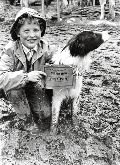 A smile from Alex Pirie, 9, as he and his dog Roy pose in a sea of mud