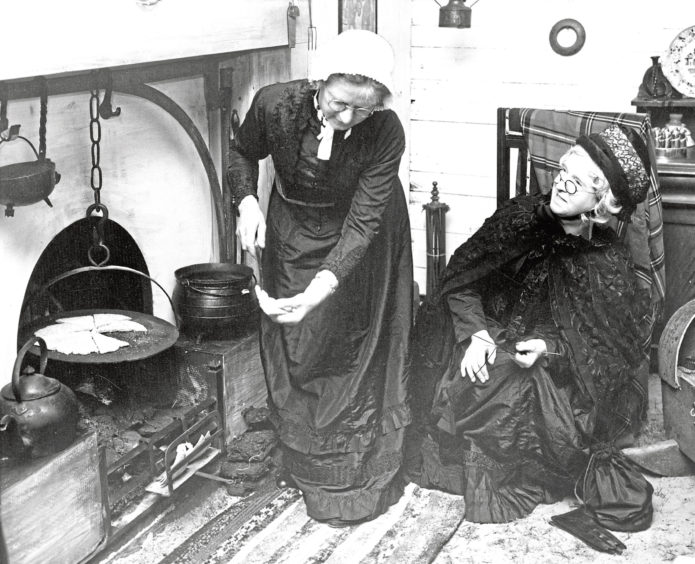 Mrs E Addison lifts bread at the Old World Kitchen