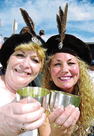 2003: Audrey Langskaill, left, and friend Wilma Burr enjoy a wee dram to celebrate the games