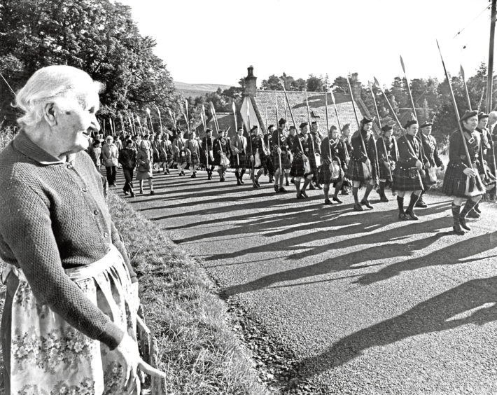 1975: Ninety-year-old Mrs Mary Taylor, Tollhouse, Strathdon, comes to the roadside to watch the Lonach marchers
