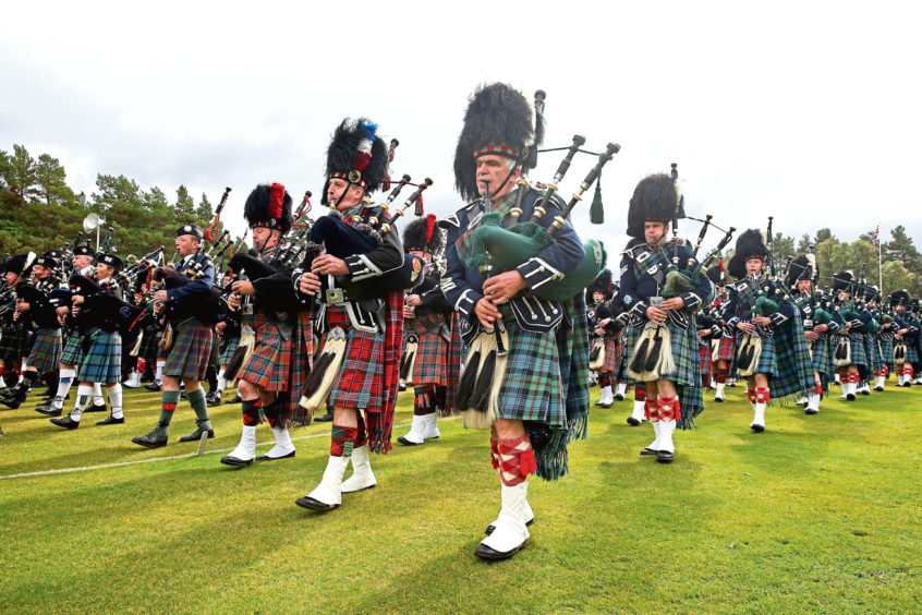 2014: Pipers  in full regalia march while entertaining the enthralled audience